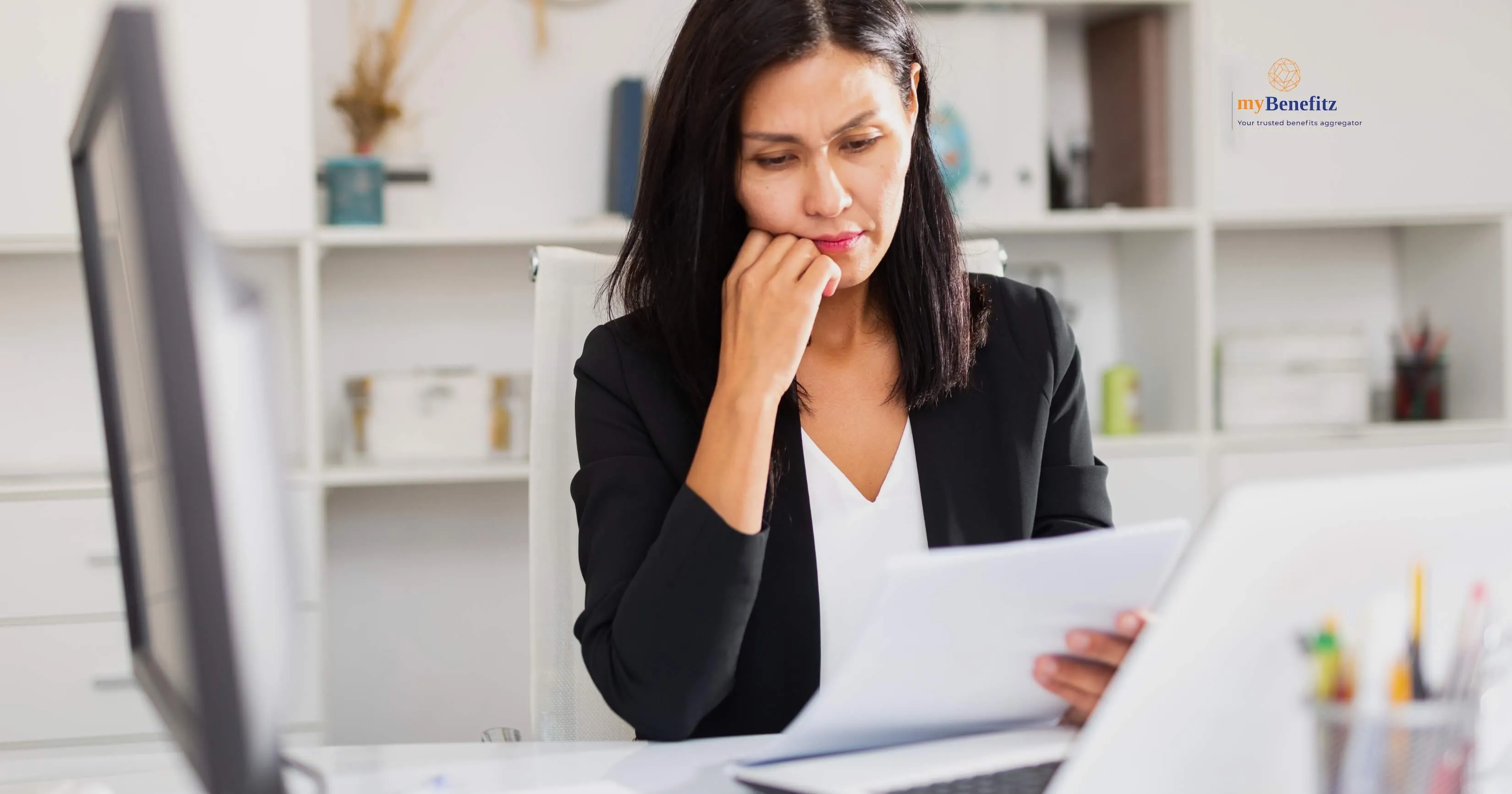 A person looking worried while reviewing financial documents